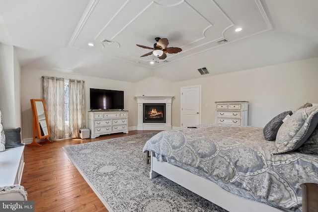 bedroom featuring ceiling fan, light hardwood / wood-style floors, and vaulted ceiling