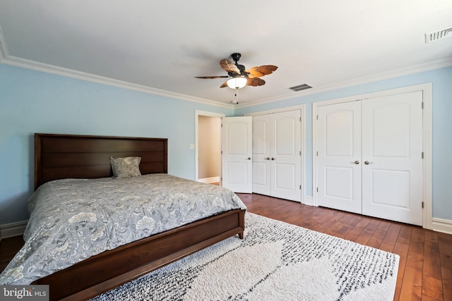 bedroom with dark hardwood / wood-style flooring, ceiling fan, and ornamental molding