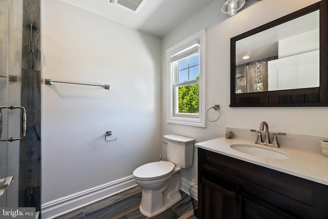 bathroom featuring hardwood / wood-style floors, vanity, curtained shower, and toilet