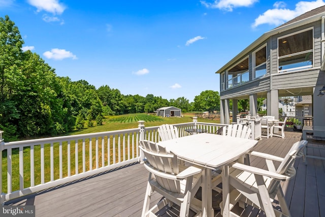 wooden terrace with a lawn