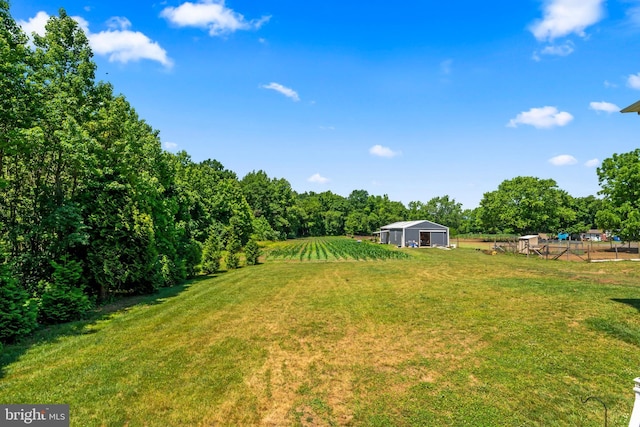 view of yard with a rural view and an outdoor structure