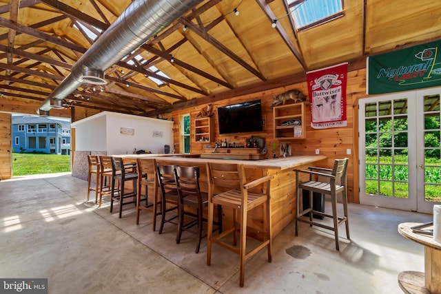 bar with wood walls and lofted ceiling