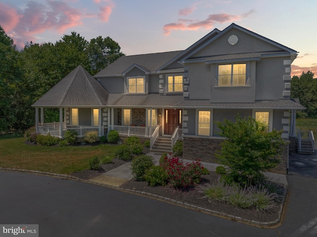 view of front of house featuring a yard and covered porch