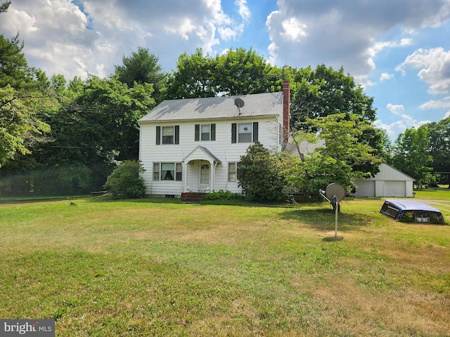 colonial-style house with a garage and a front yard