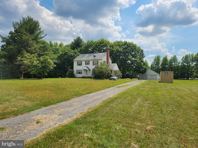 exterior space featuring a front lawn and a shed