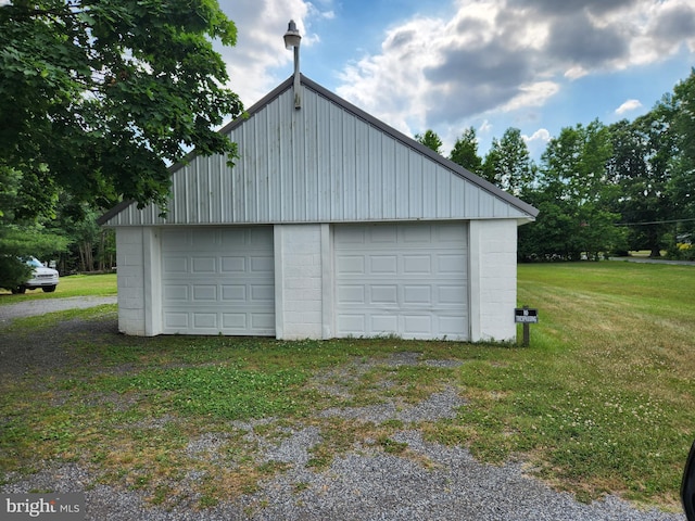 garage featuring a lawn