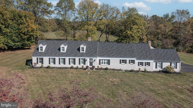 new england style home with a front yard