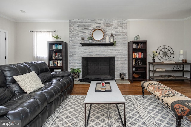 living room featuring a fireplace, hardwood / wood-style flooring, and ornamental molding