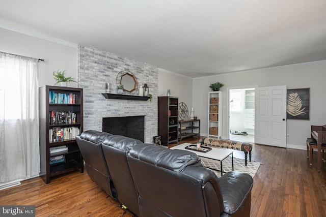 living room featuring a fireplace, ornamental molding, and dark wood-type flooring