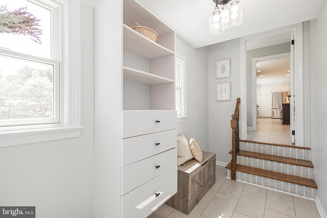 walk in closet with light tile patterned floors