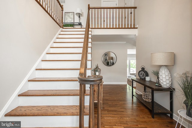 stairway with hardwood / wood-style floors