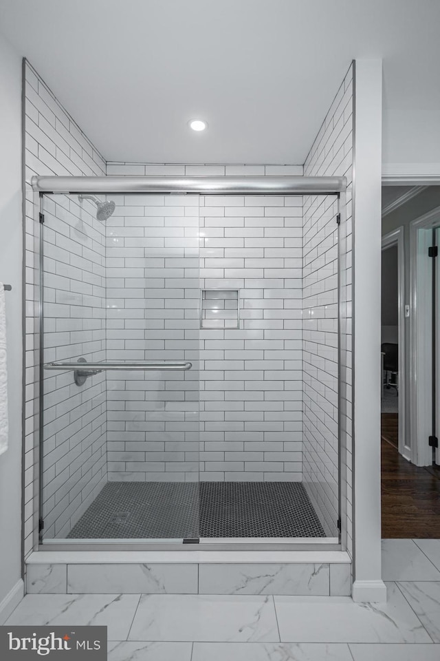 bathroom with a shower with door