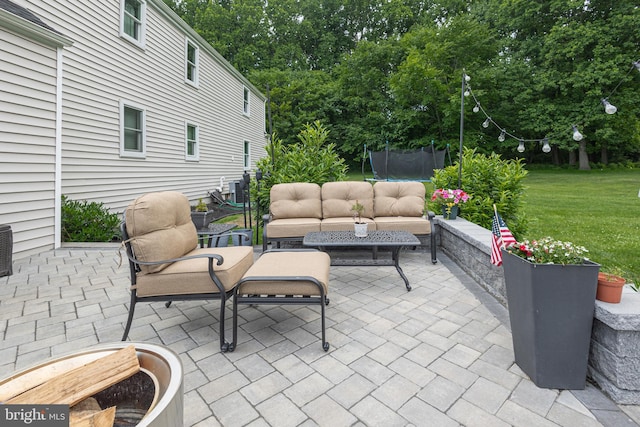 view of patio / terrace featuring central AC unit, an outdoor hangout area, and a trampoline