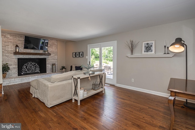 living room with a fireplace and dark hardwood / wood-style floors