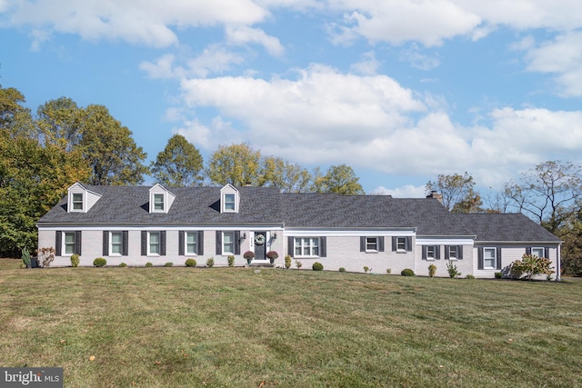 cape cod house featuring a front yard