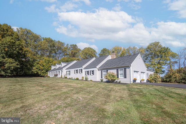 ranch-style house featuring a garage and a front lawn