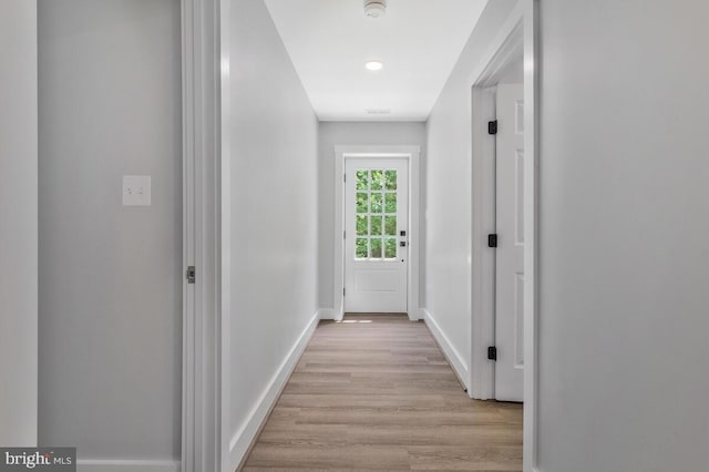 corridor with light hardwood / wood-style flooring