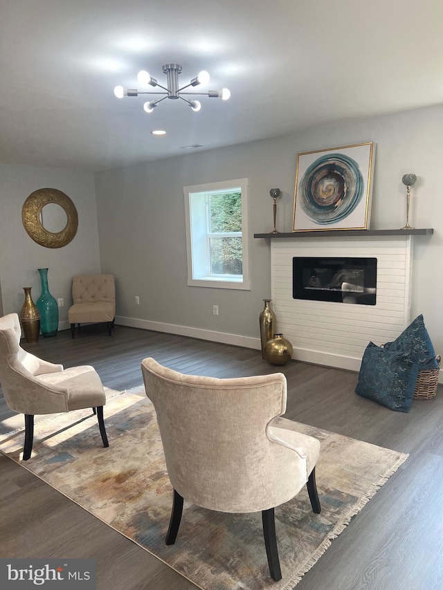 living room featuring a chandelier and dark hardwood / wood-style floors