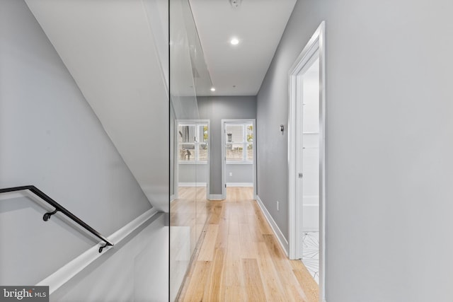 corridor with recessed lighting, light wood-style flooring, and baseboards