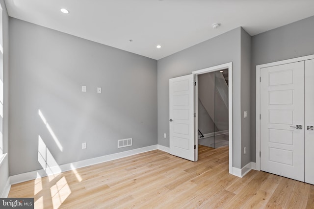 unfurnished bedroom with light wood-style floors, recessed lighting, visible vents, and baseboards