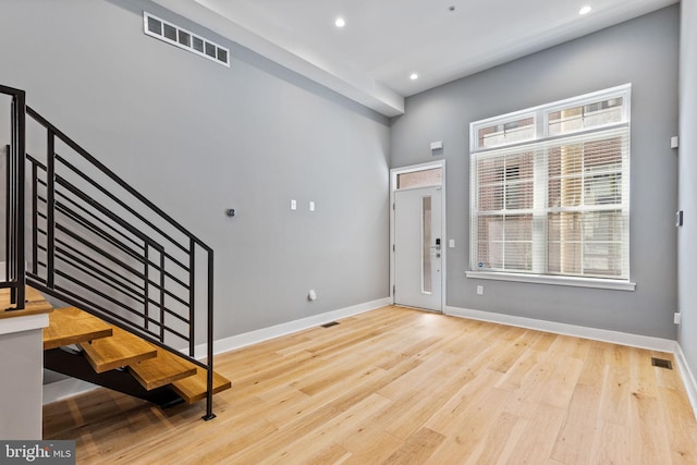 foyer entrance featuring recessed lighting, visible vents, stairway, light wood-style floors, and baseboards