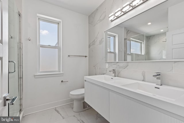 full bathroom featuring marble finish floor, double vanity, a sink, and a marble finish shower