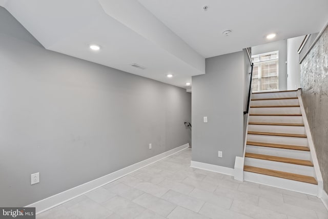 basement featuring recessed lighting, visible vents, stairway, and baseboards