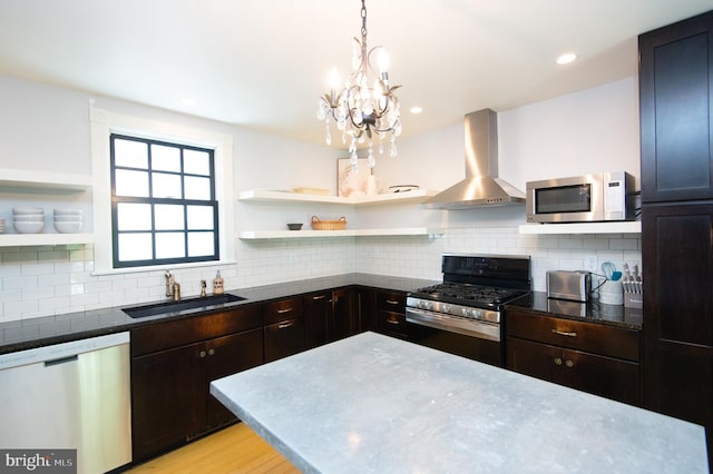 kitchen with sink, wall chimney range hood, stainless steel appliances, and tasteful backsplash