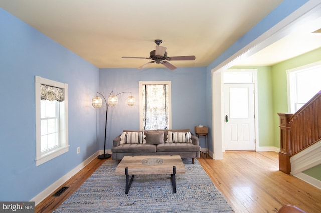 living room featuring ceiling fan and light wood-type flooring