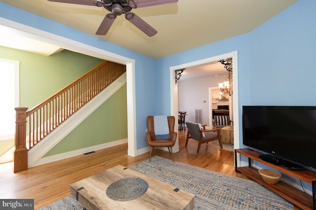 living area featuring hardwood / wood-style floors and a chandelier