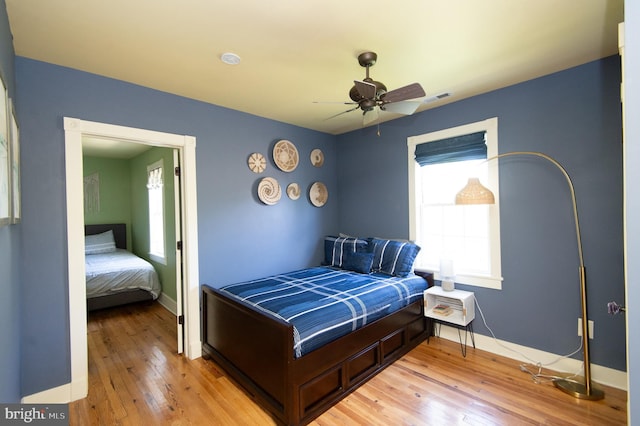 bedroom with ceiling fan and light hardwood / wood-style flooring