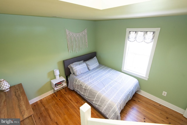 bedroom with wood-type flooring