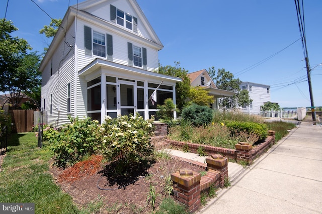 view of front of property with a sunroom