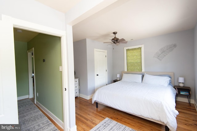 bedroom featuring hardwood / wood-style floors and ceiling fan