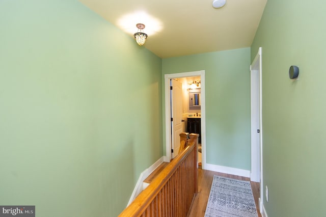 hallway with hardwood / wood-style flooring