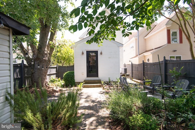 rear view of property with central AC unit