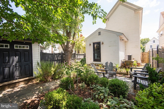 rear view of property featuring central AC unit and a patio area