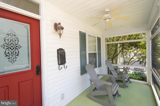 entrance to property with ceiling fan and covered porch