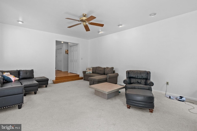 carpeted living room with ceiling fan