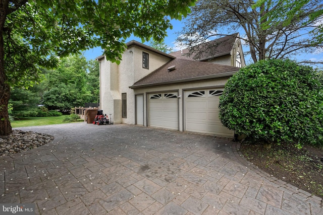 view of side of property with a garage