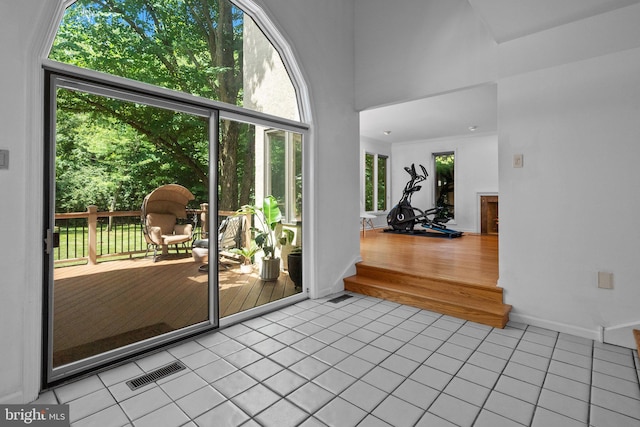 doorway to outside with light tile patterned floors