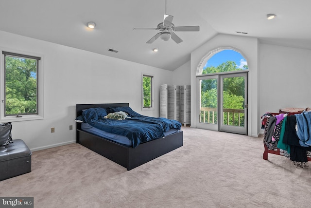 bedroom featuring multiple windows, ceiling fan, light carpet, and vaulted ceiling