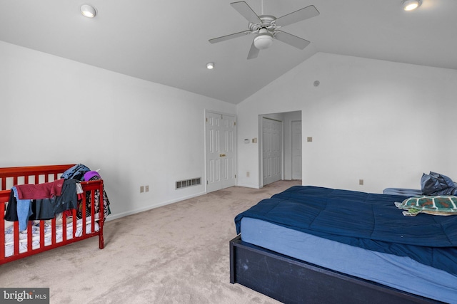 carpeted bedroom with ceiling fan and vaulted ceiling