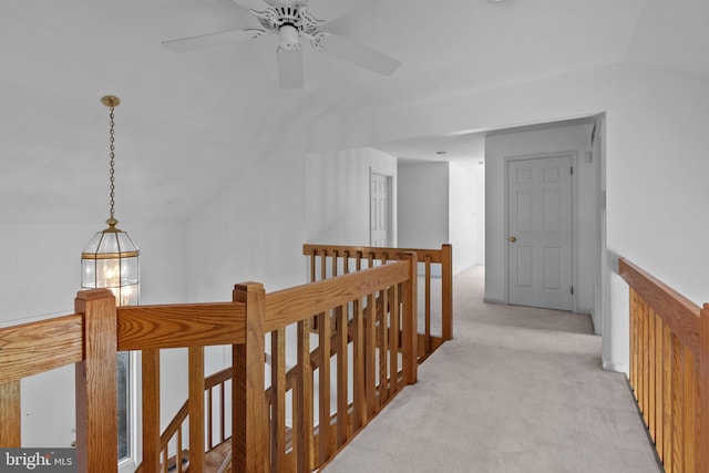 hall with light carpet and lofted ceiling