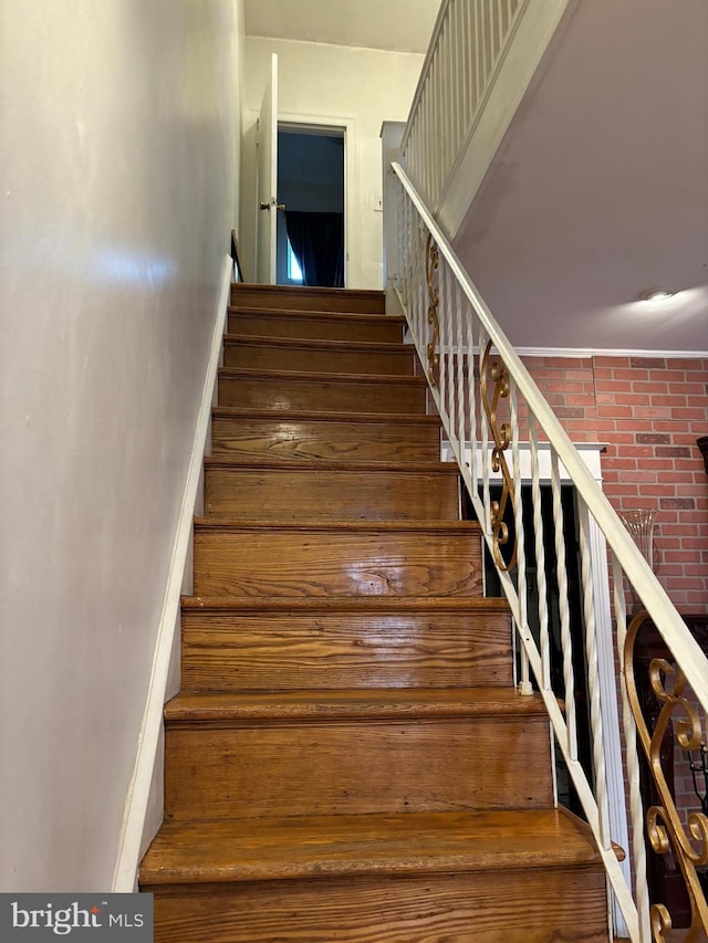 staircase with brick wall