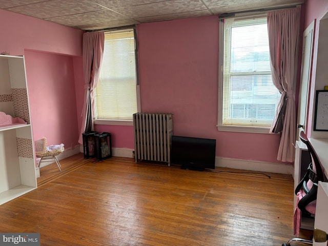 interior space featuring hardwood / wood-style flooring and radiator heating unit