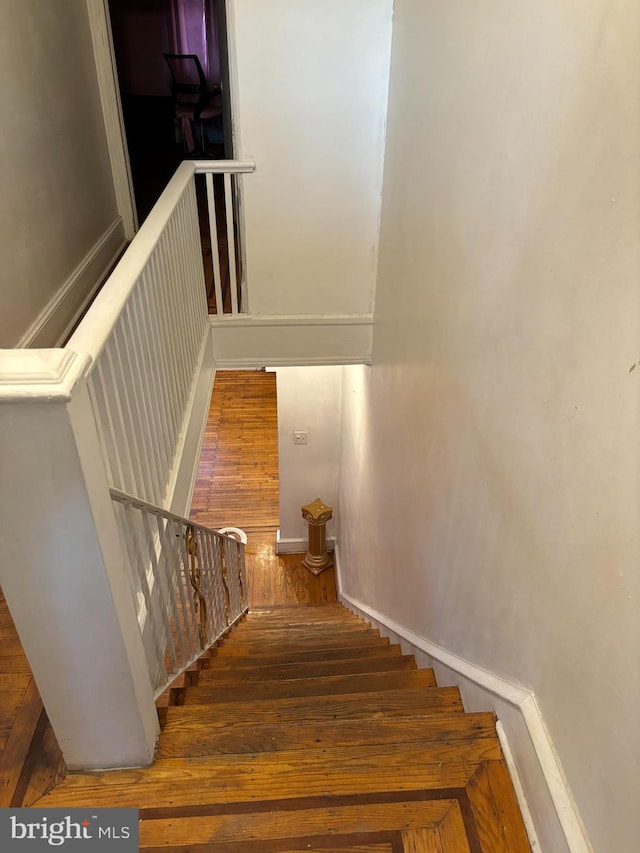 stairway featuring hardwood / wood-style floors