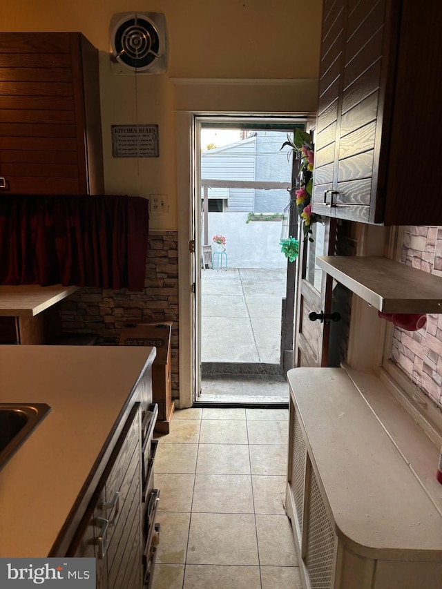 doorway with light tile patterned floors