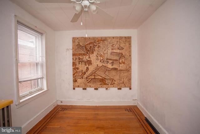 interior space featuring hardwood / wood-style floors, ceiling fan, and a healthy amount of sunlight