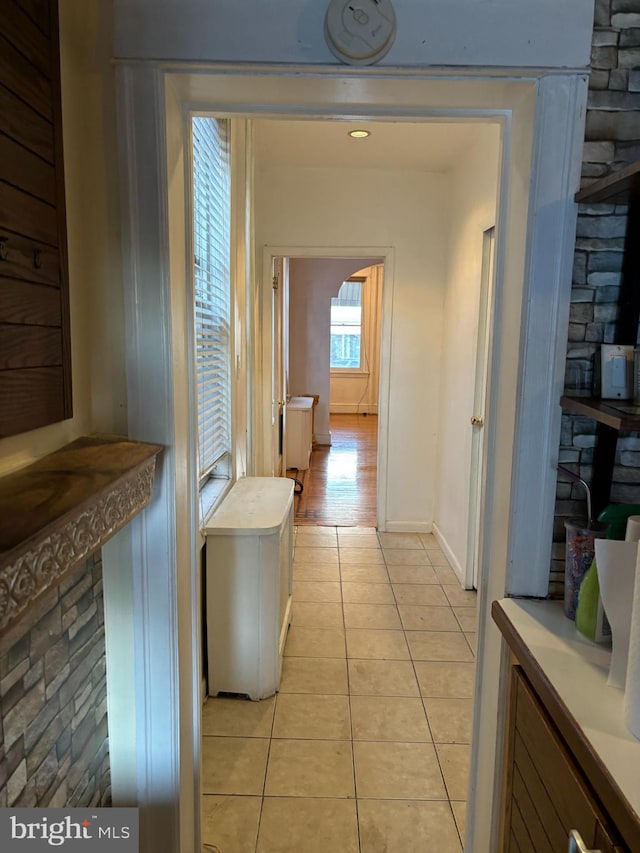 hallway featuring light tile patterned flooring